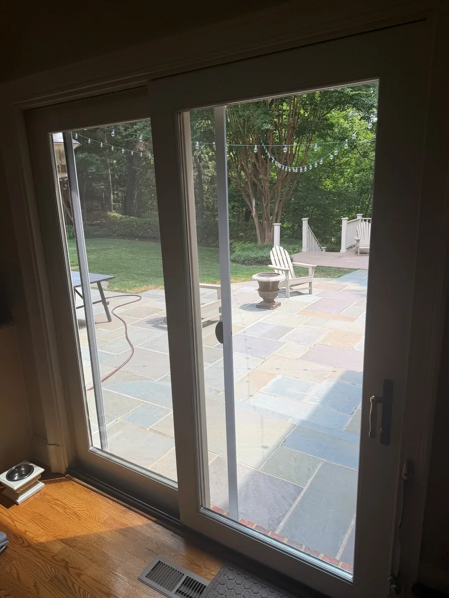 Sliding glass patio doors opening onto a stone terrace.