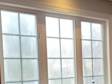 Cloudy kitchen window glass before replacement.