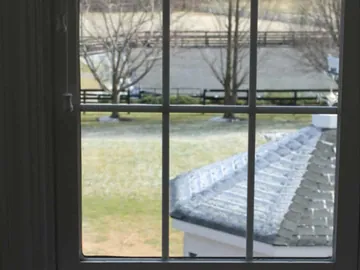 Clear divided-light window sash after glass replacement.