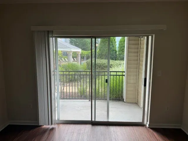 A sliding glass door opens toward a covered balcony.