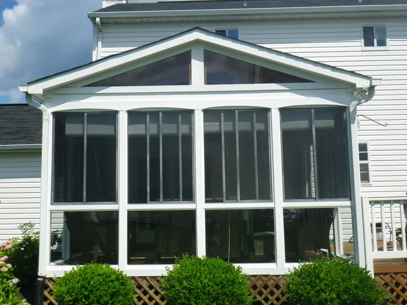 Front view of a white gabled porch enclosure.