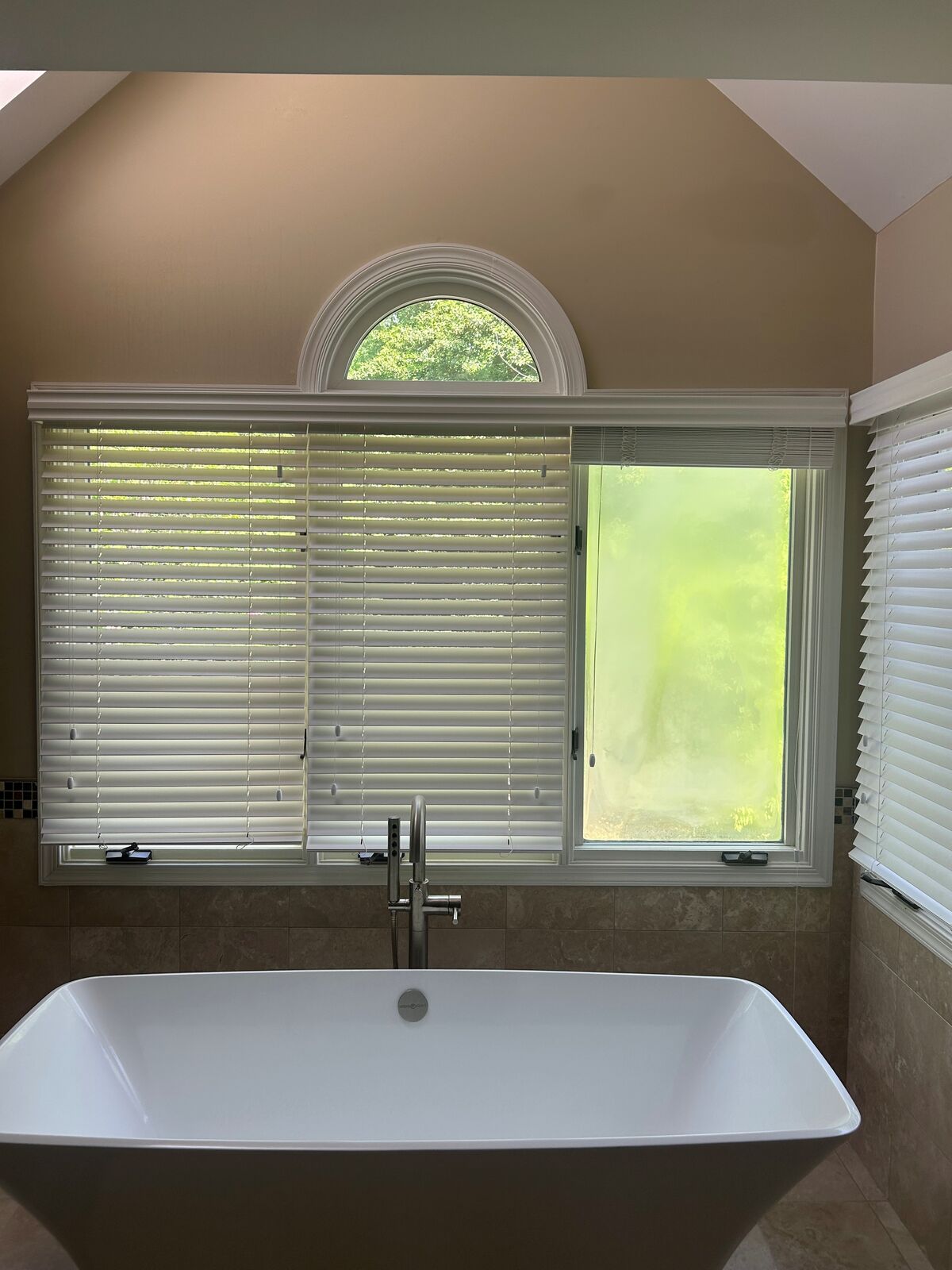 Clouding across the right-hand bathroom window above a bathtub