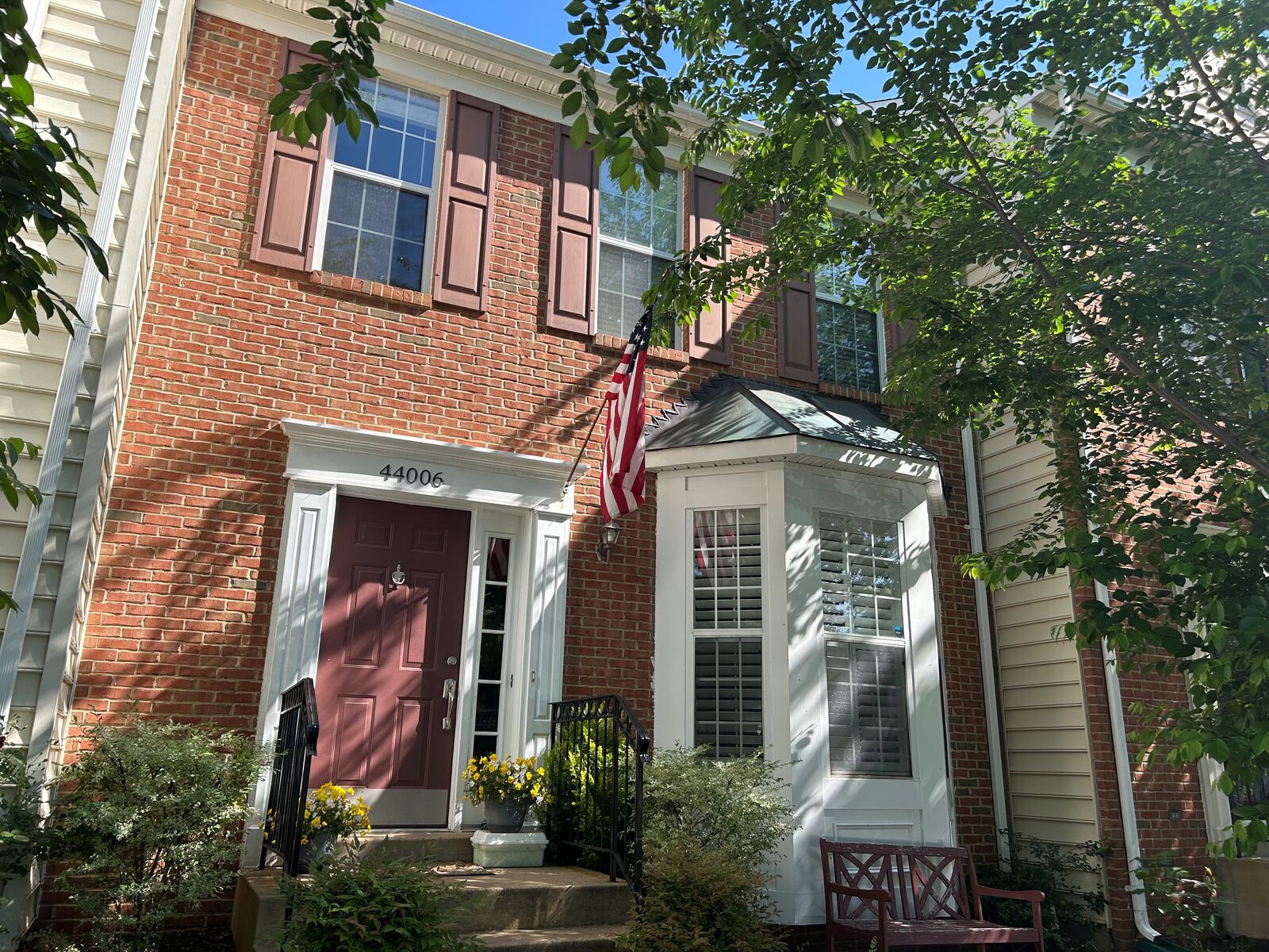 A townhouse with a bay window and upper-story windows