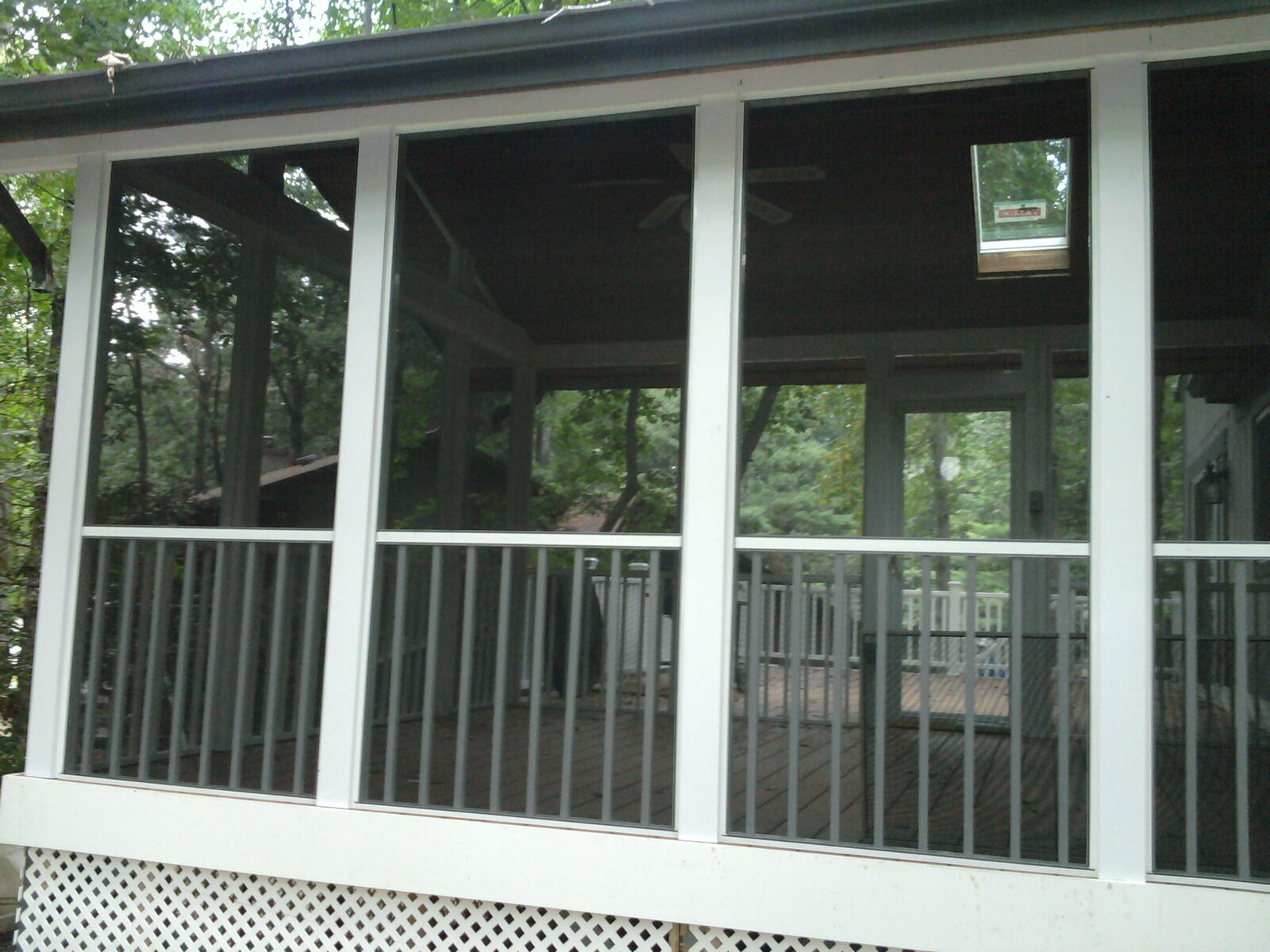 A broad porch screen wall above white railings