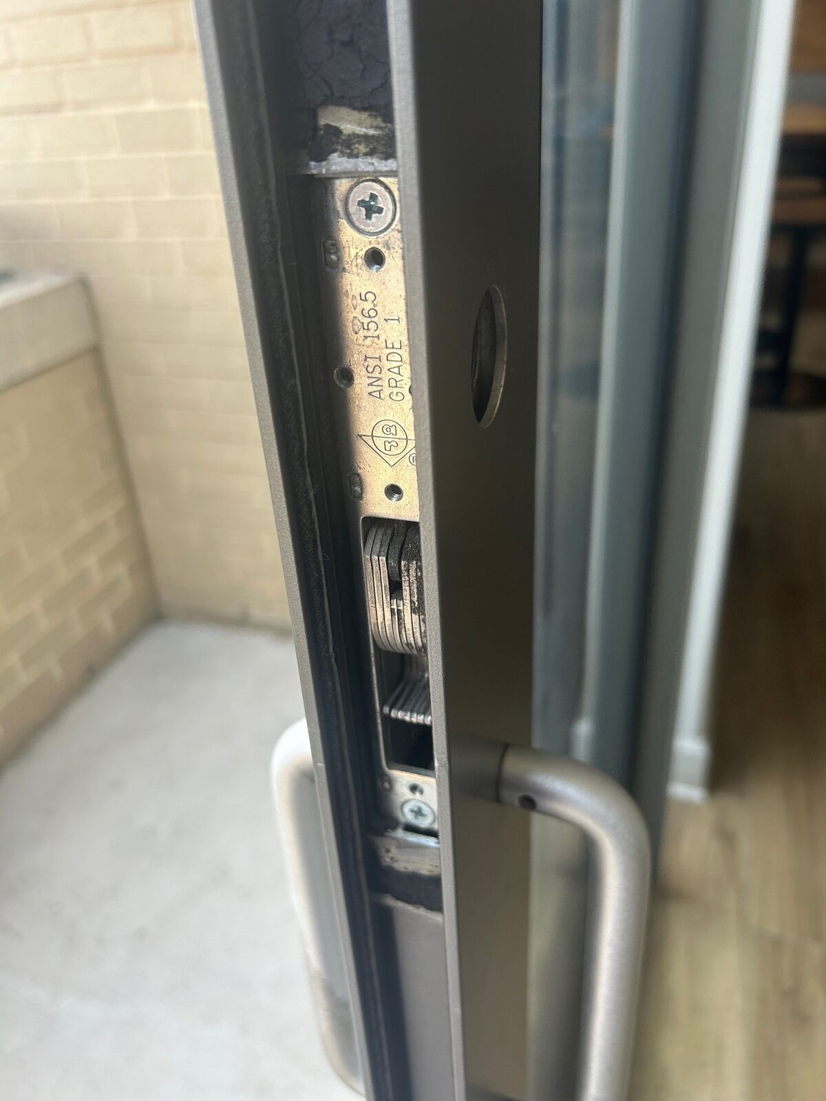 The edge of a sliding door panel showing its lock mechanism