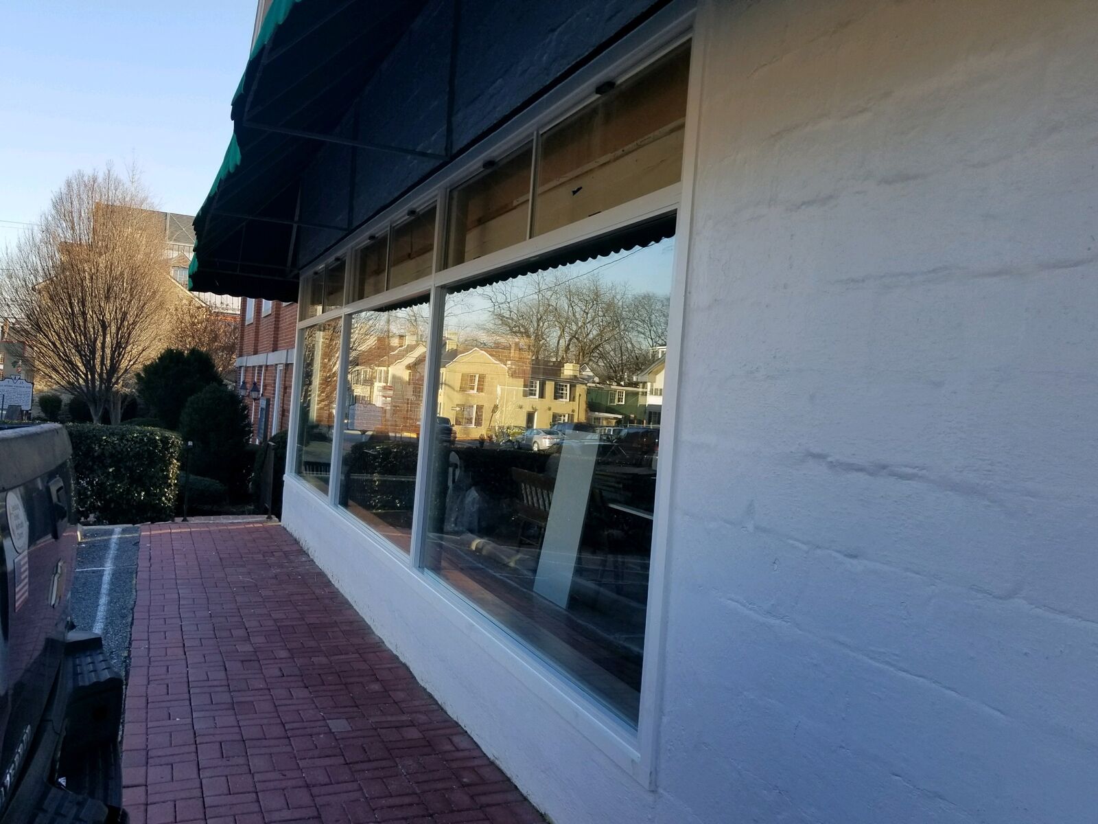 A row of storefront windows beneath a dark awning